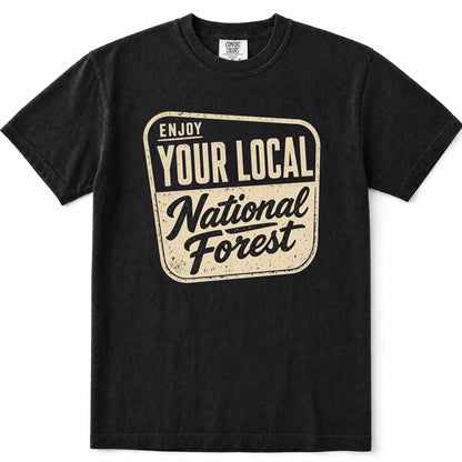 Black short-sleeve t-shirt with a distressed cream-colored graphic on the front that reads 'ENJOY YOUR LOCAL National Forest'.