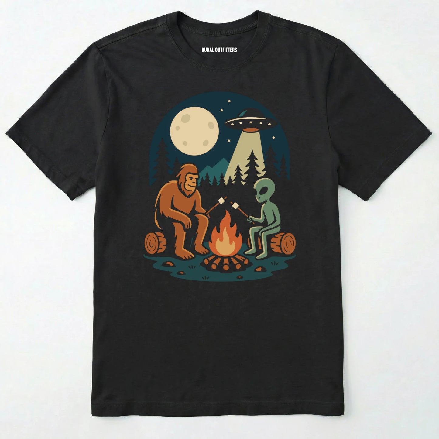 Black bigfoot and alien shirt, featuring a sasquatch and an alien roasting marshmallows around a campfire with moon and ufo graphic on a white background.