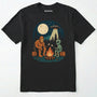 Black bigfoot and alien shirt, featuring a sasquatch and an alien roasting marshmallows around a campfire with moon and ufo graphic on a white background.