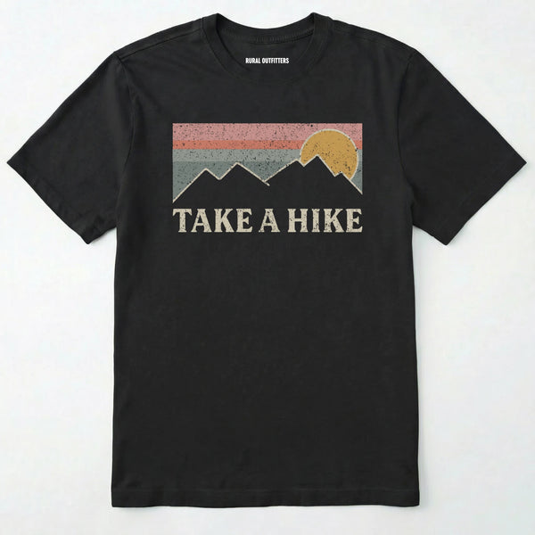 Black take a hike shirt with retro sunset and mountain graphic on a white background.