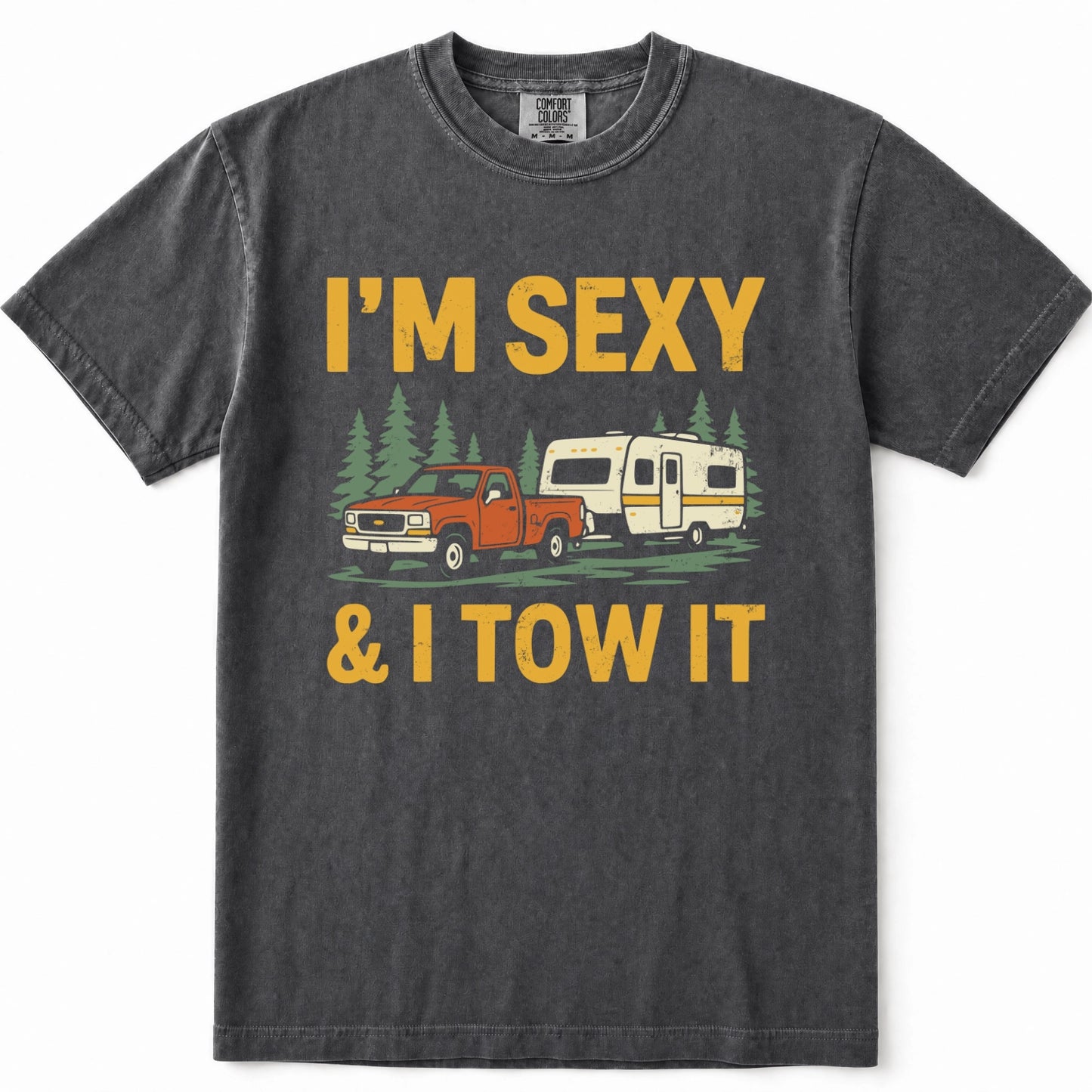 Pepper heathered t-shirt with a graphic print that reads 'I'M SEXY & I TOW IT' in yellow text, featuring an illustration of an orange pickup truck towing a cream camper trailer with green pine trees in the background.
