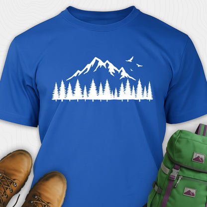 Blue wild t-shirt with a minimalist mountain and pine tree graphic, shown flat with boots and a backpack