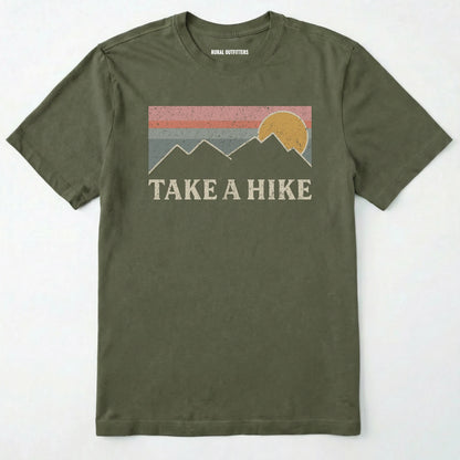Military Green take a hike shirt with retro sunset and mountain graphic on a white background.