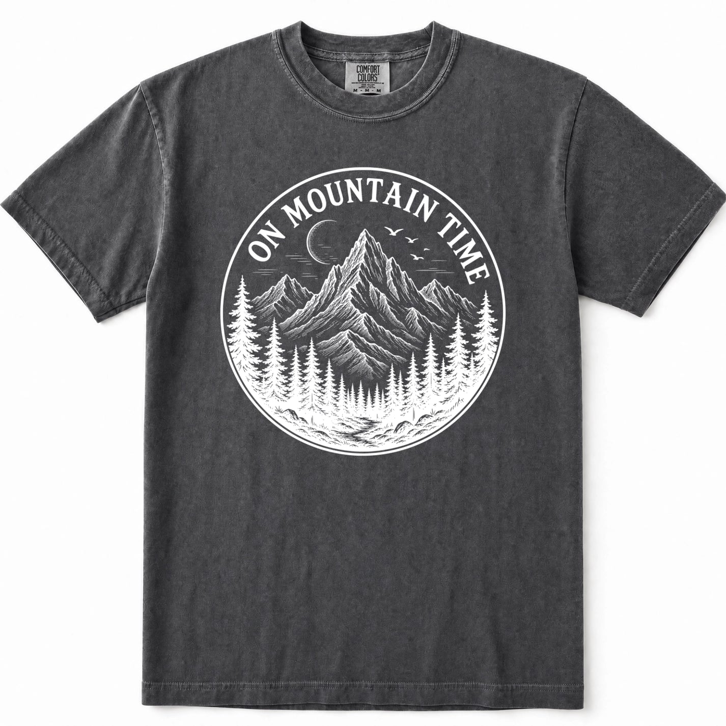 Grey mineral-wash t-shirt with a circular white graphic on the chest depicting a mountain, pine trees, and a crescent moon with the text 'ON MOUNTAIN TIME'.