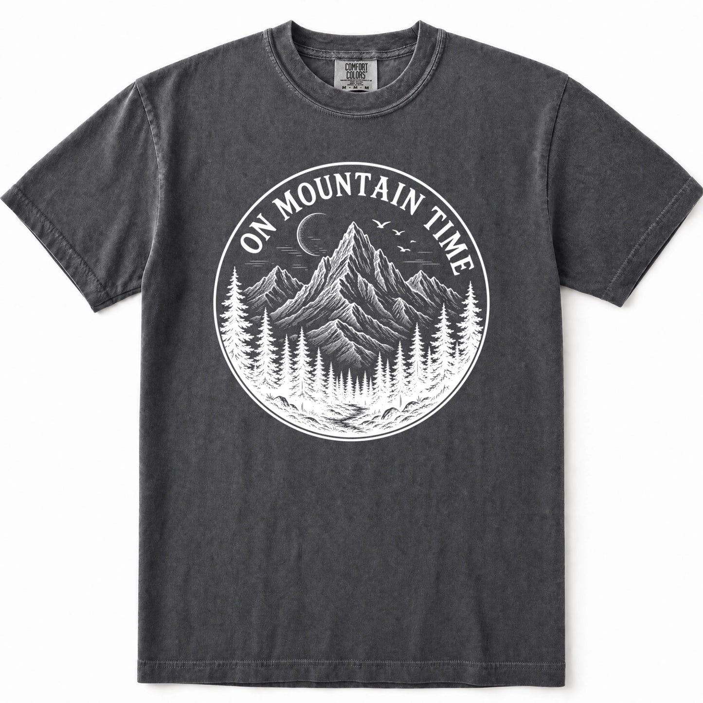 Grey mineral-wash t-shirt with a circular white graphic on the chest depicting a mountain, pine trees, and a crescent moon with the text 'ON MOUNTAIN TIME'.