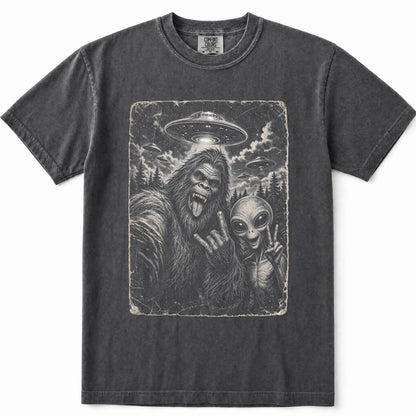 Pepper crewneck t-shirt featuring a vintage-style graphic print of Bigfoot and an alien making peace signs, with a UFO in the sky above.