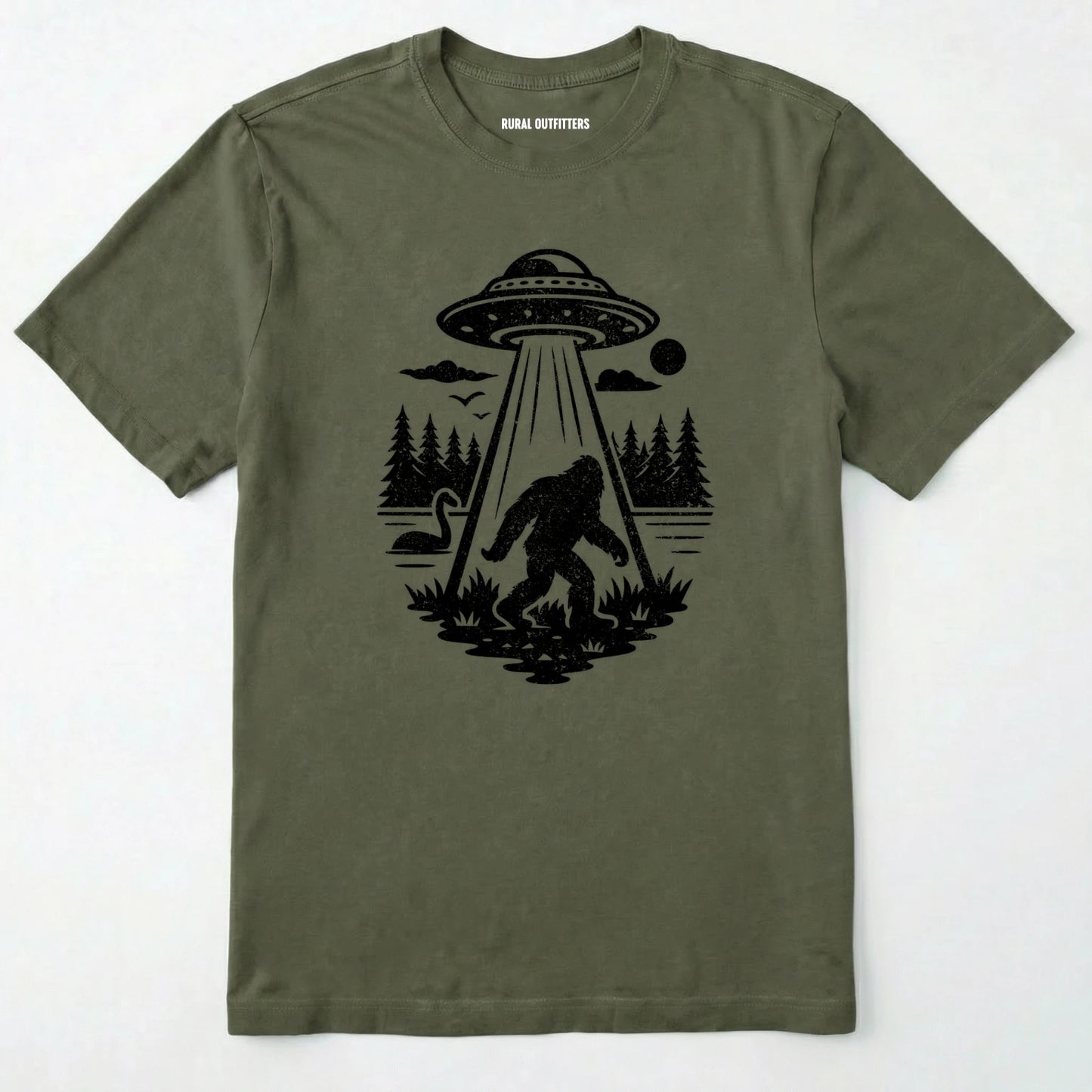Military Green monster shirt with Bigfoot, a forest scene, and a UFO beam graphic on a white background.