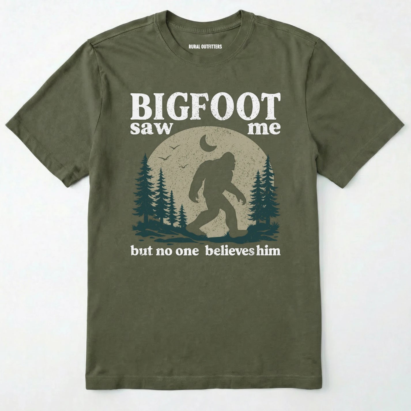 Military Green bigfoot saw me shirt with a vintage outdoor sasquatch in the forest graphic on a white background.