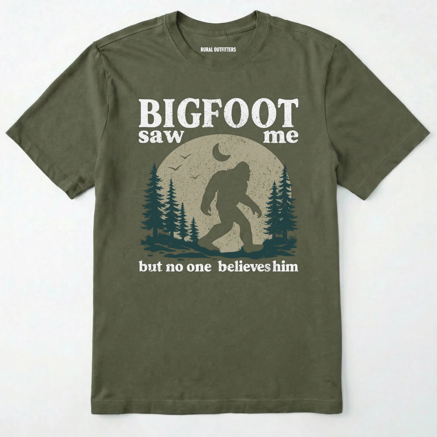 Military Green bigfoot saw me shirt with a vintage outdoor sasquatch in the forest graphic on a white background.