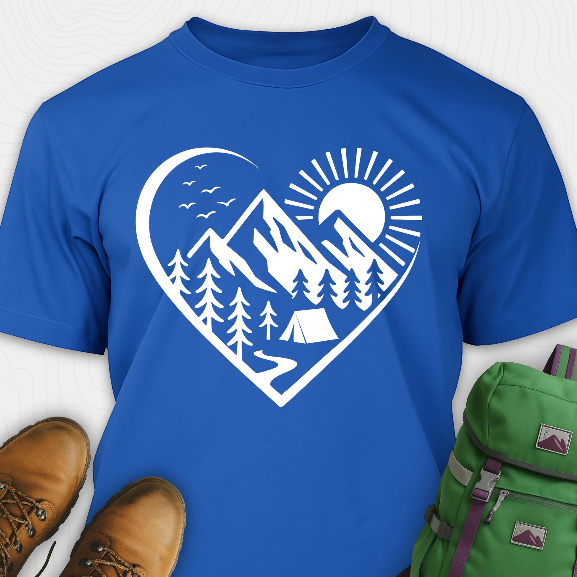 Blue nature t-shirt featuring heart graphic with mountains, trees, and tent illustration