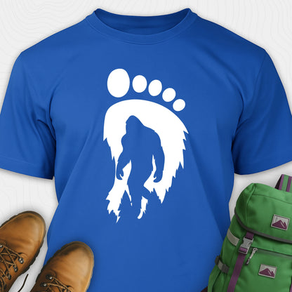 Blue bigfoot t-shirt with cryptid themed footprint graphic and sasquatch silhouette