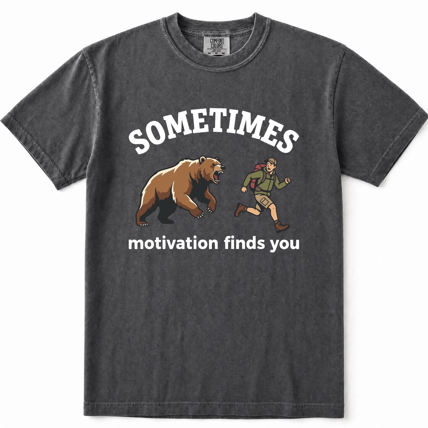 Pepper acid-wash graphic t-shirt featuring a brown grizzly bear and a hiking trail guide illustration with the text 'SOMETIMES motivation finds you' printed in white.