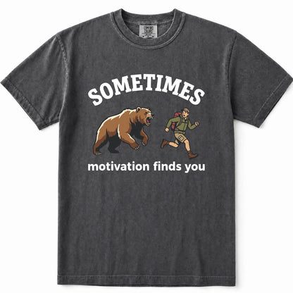 Pepper acid-wash graphic t-shirt featuring a brown grizzly bear and a hiking trail guide illustration with the text 'SOMETIMES motivation finds you' printed in white.