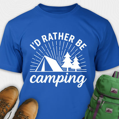 Royal blue camping shirt with 'I'd Rather Be Camping' design, brown boots, and green backpack on a white background