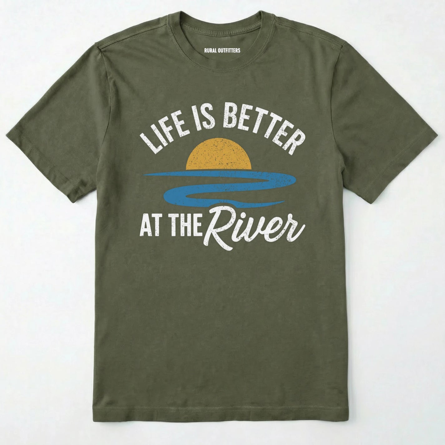 Military Green river shirt with 'life is better at the river' design, paired with brown boots and a green backpack on a light grey background.