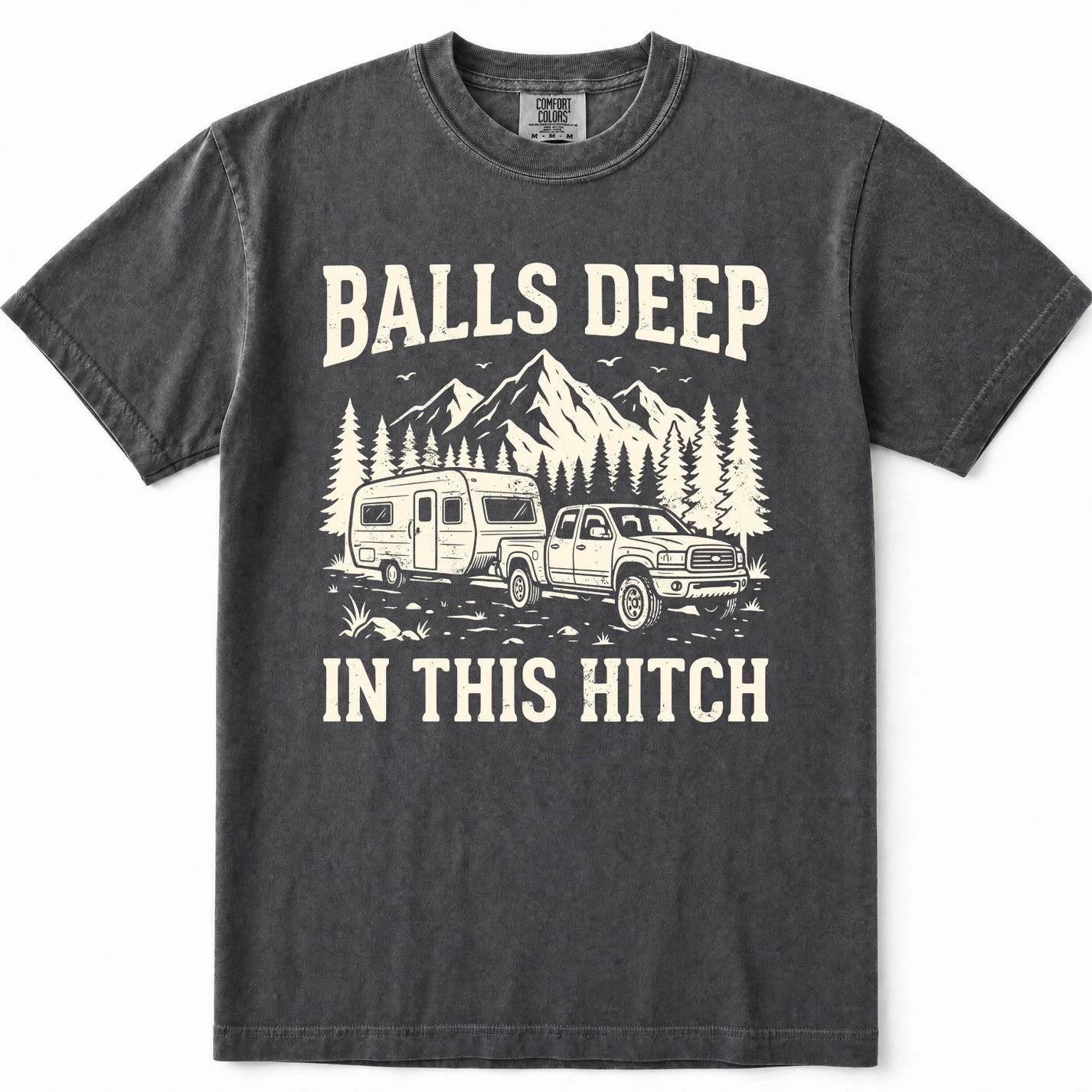 Pepper graphic t-shirt featuring a cream-colored print of a pickup truck towing a camper trailer with mountains and pine trees in the background. The text reads 'BALLS DEEP' above the graphic and 'IN THIS HITCH' below.