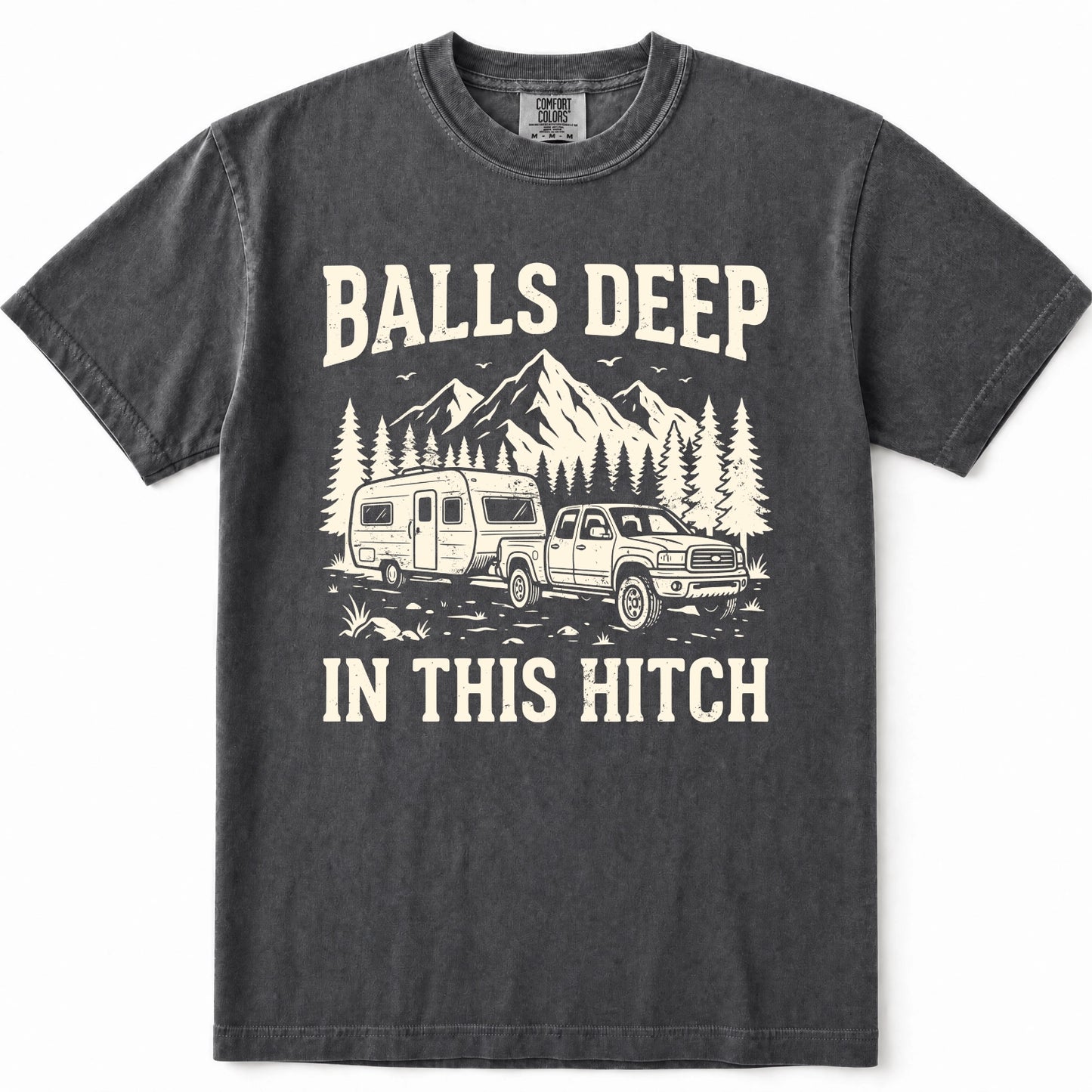 Pepper graphic t-shirt featuring a cream-colored print of a pickup truck towing a camper trailer with mountains and pine trees in the background. The text reads 'BALLS DEEP' above the graphic and 'IN THIS HITCH' below.