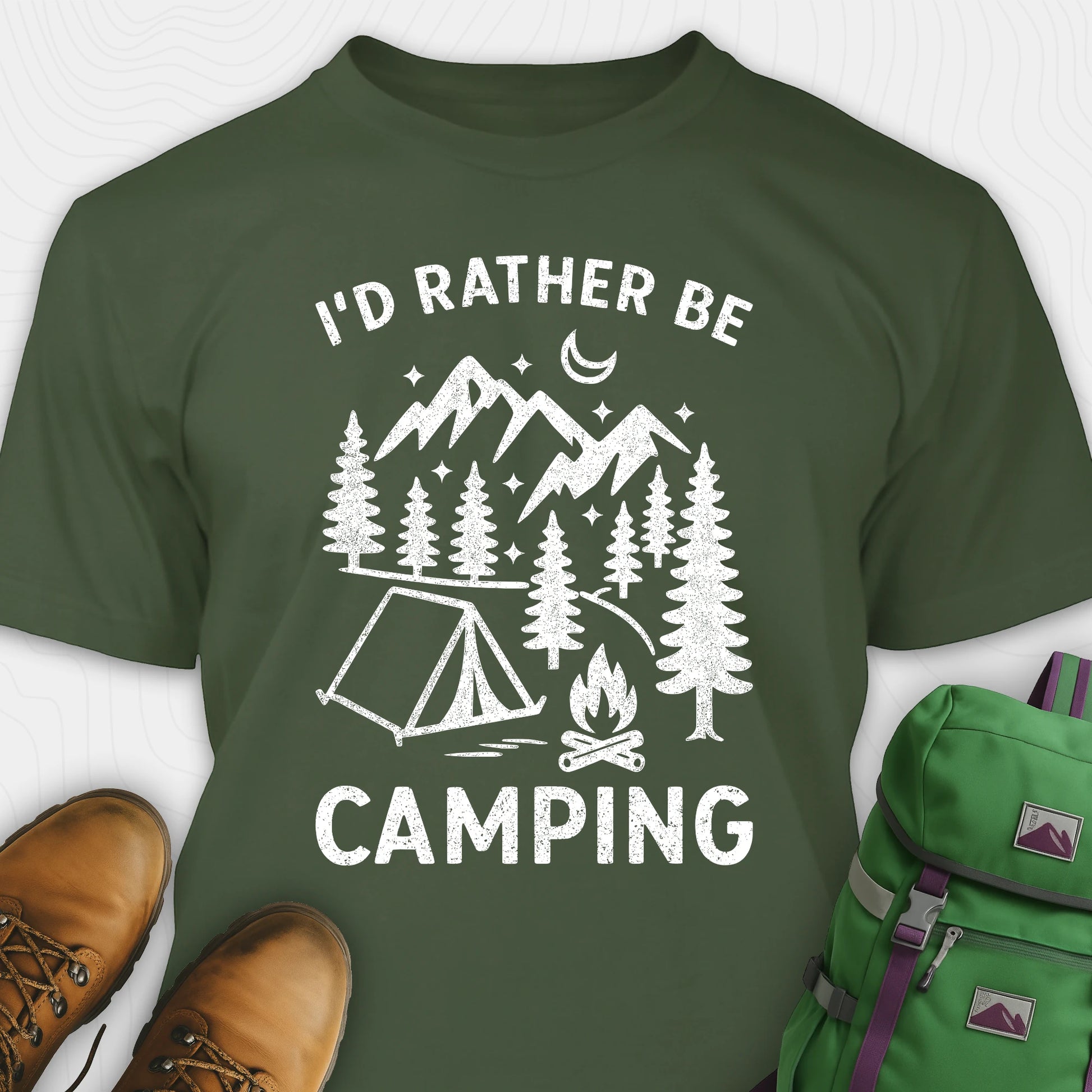Green t-shirt with 'I'd Rather Be Camping' design, brown boots, and green backpack on a white background