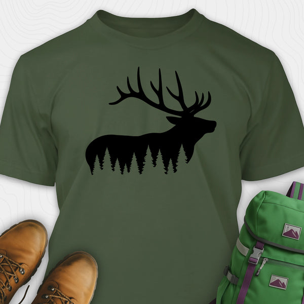 Green elk shirt with black elk silhouette design, paired with brown boots and a green backpack on a white background.