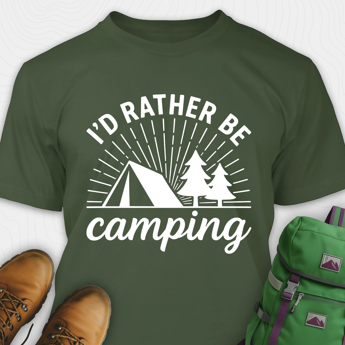 Military green camping shirt with 'I'd Rather Be Camping' design, brown boots, and green backpack on a white background