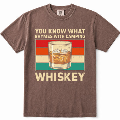 Espresso short-sleeve crewneck t-shirt with a vintage-style graphic that reads 'YOU KNOW WHAT RHYMES WITH CAMPING WHISKEY' around an illustration of a whiskey glass. The shirt is shown flat against a white background.
