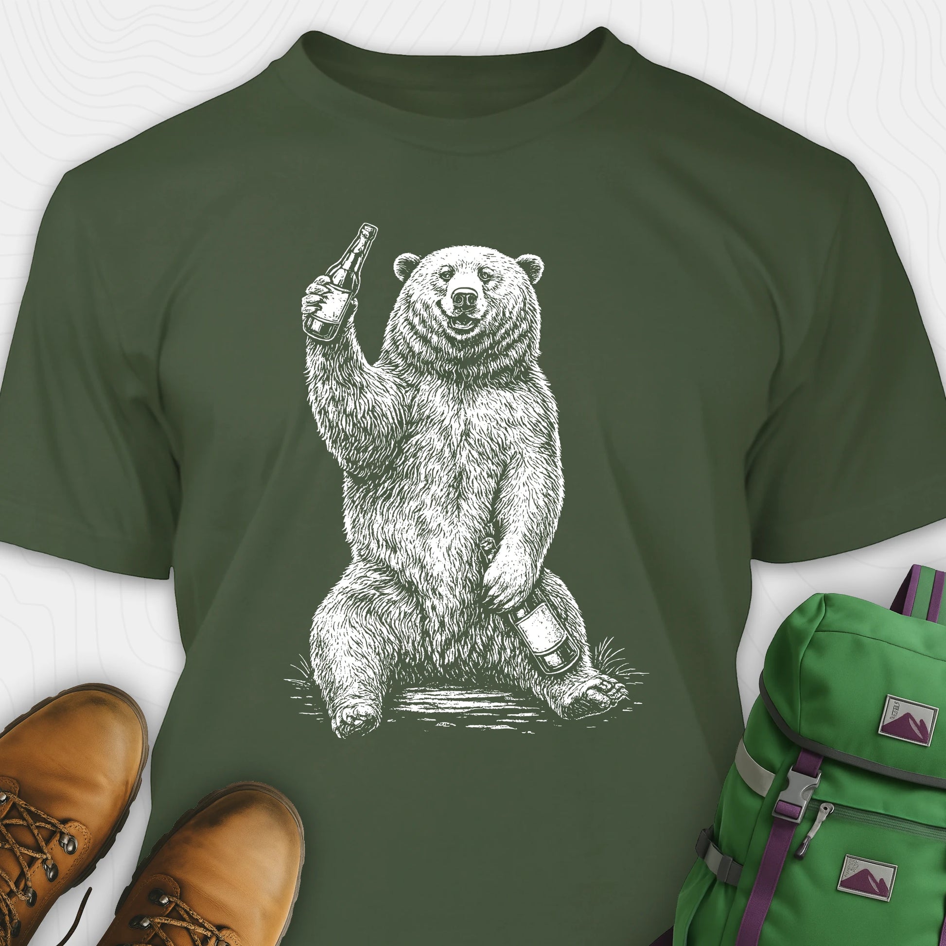 Green brown bear shirt with a bear graphic holding a beer bottle, paired with brown shoes and a green backpack on a white background.
