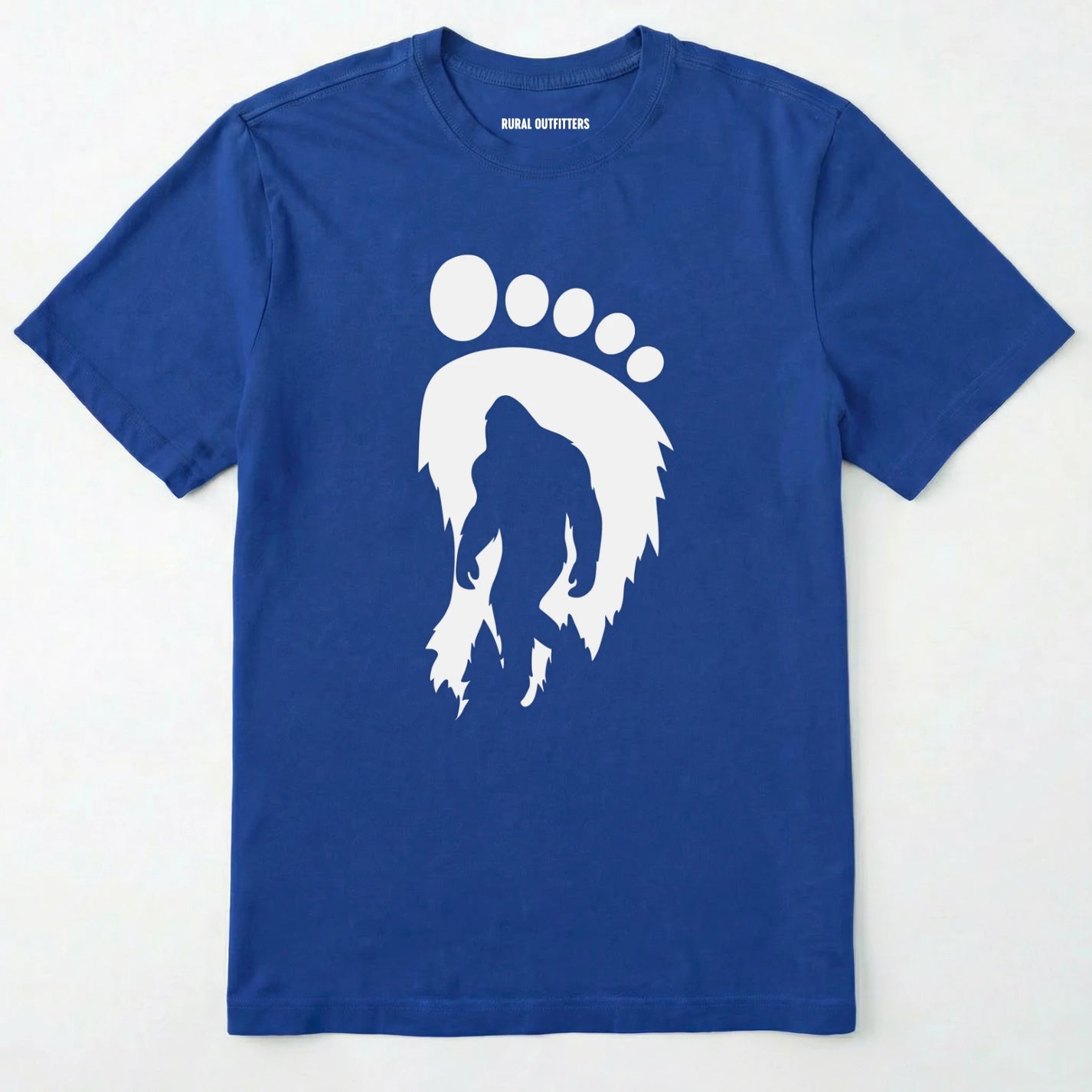 Royal bigfoot t-shirt with cryptid-themed footprint graphic and sasquatch silhouette on a white background.