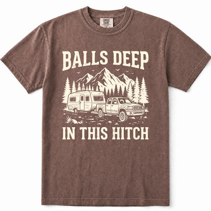 Espresso brown short-sleeve crewneck t-shirt with a vintage-style cream graphic of a pickup truck towing a camper trailer in front of mountains and pine trees, with the text 'BALLS DEEP' above and 'IN THIS HITCH' below.