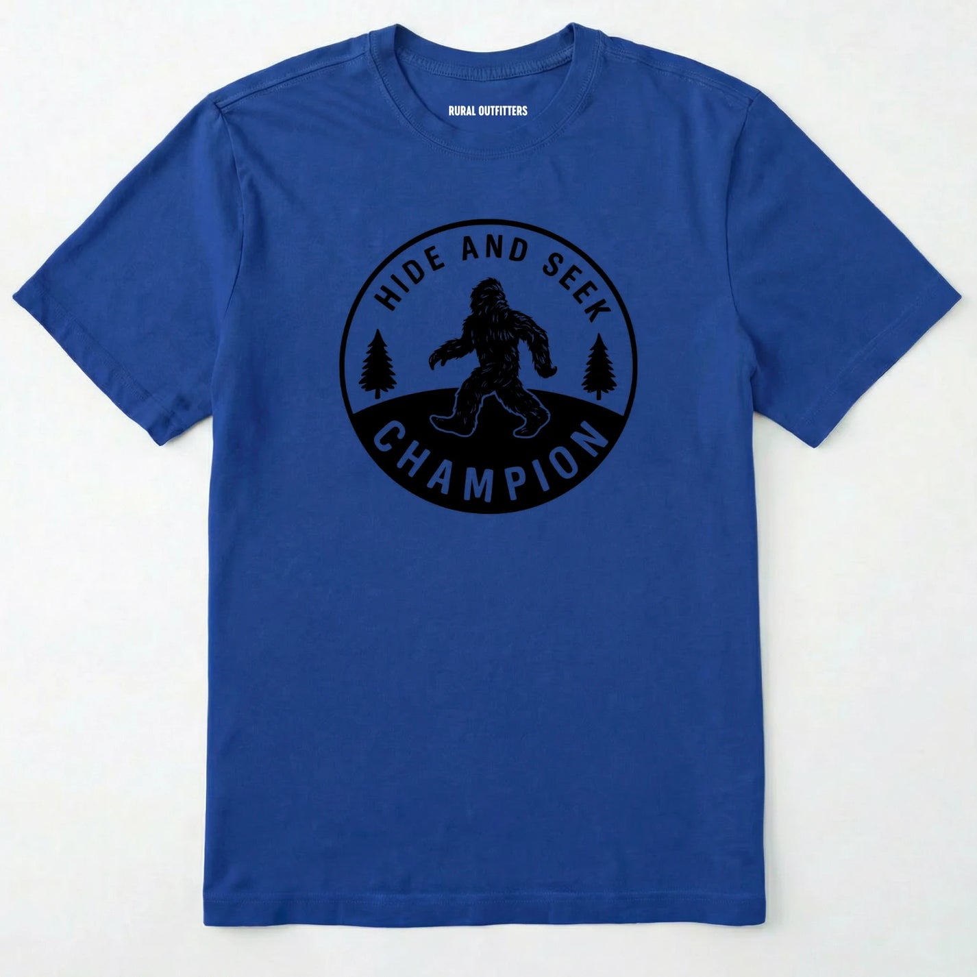 Royal bigfoot hide and seek champion shirt with forest emblem on a white background.
