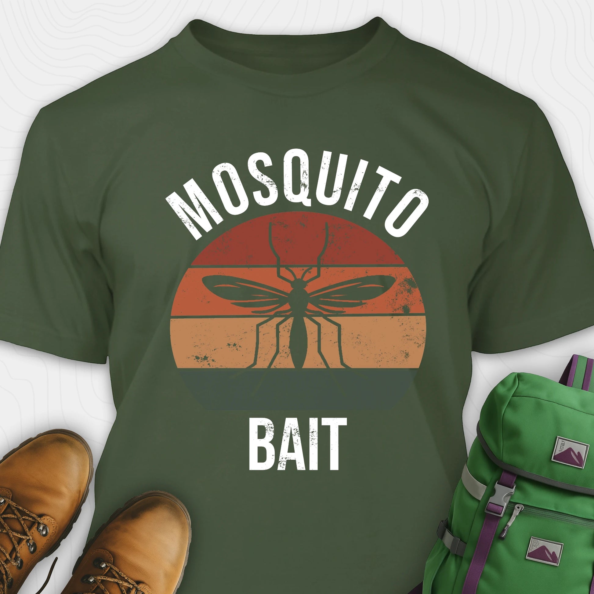 Green mosquito shirt with mosquito graphic and 'Mosquito Bait' text, paired with brown boots and a green backpack.