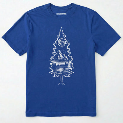 Royal tree t-shirt featuring a detailed white graphic of a pine tree silhouette. the tree outline contains a landscape scene: a mountain peak rising over a forested shoreline, with its reflection visible in a lake below. above the mountain is a starry night sky and a full or partial circle representing the moon or sun.