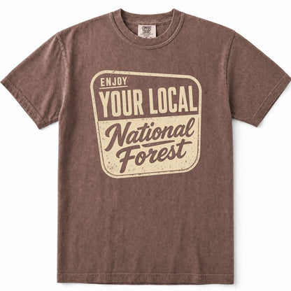 Espresso short-sleeve crewneck t-shirt with a distressed beige graphic on the front that reads 'ENJOY YOUR LOCAL National Forest'.