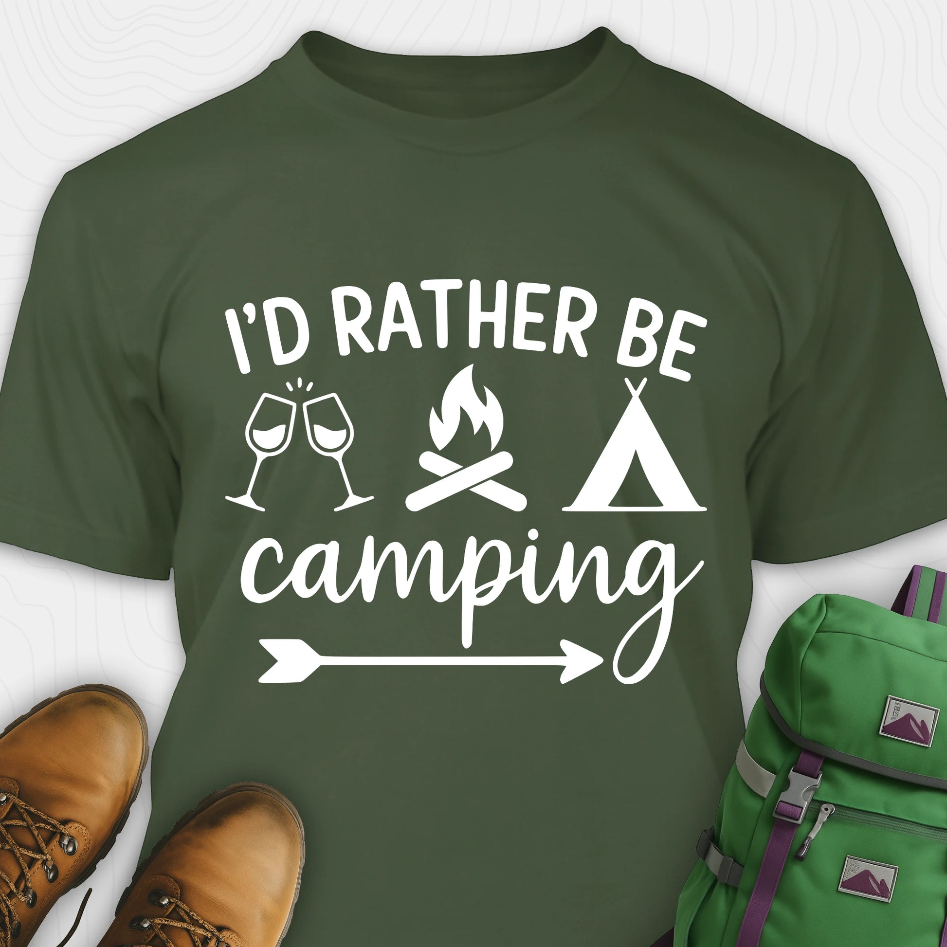 Green women's camping shirt  with 'I'd Rather Be Camping' design, brown boots, and green backpack on a white background