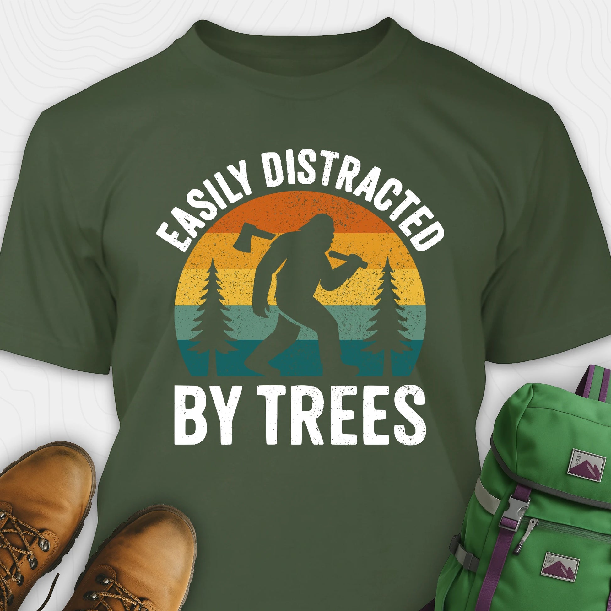 Green funny sasquatch shirt featuring bigfoot silhouette and trees