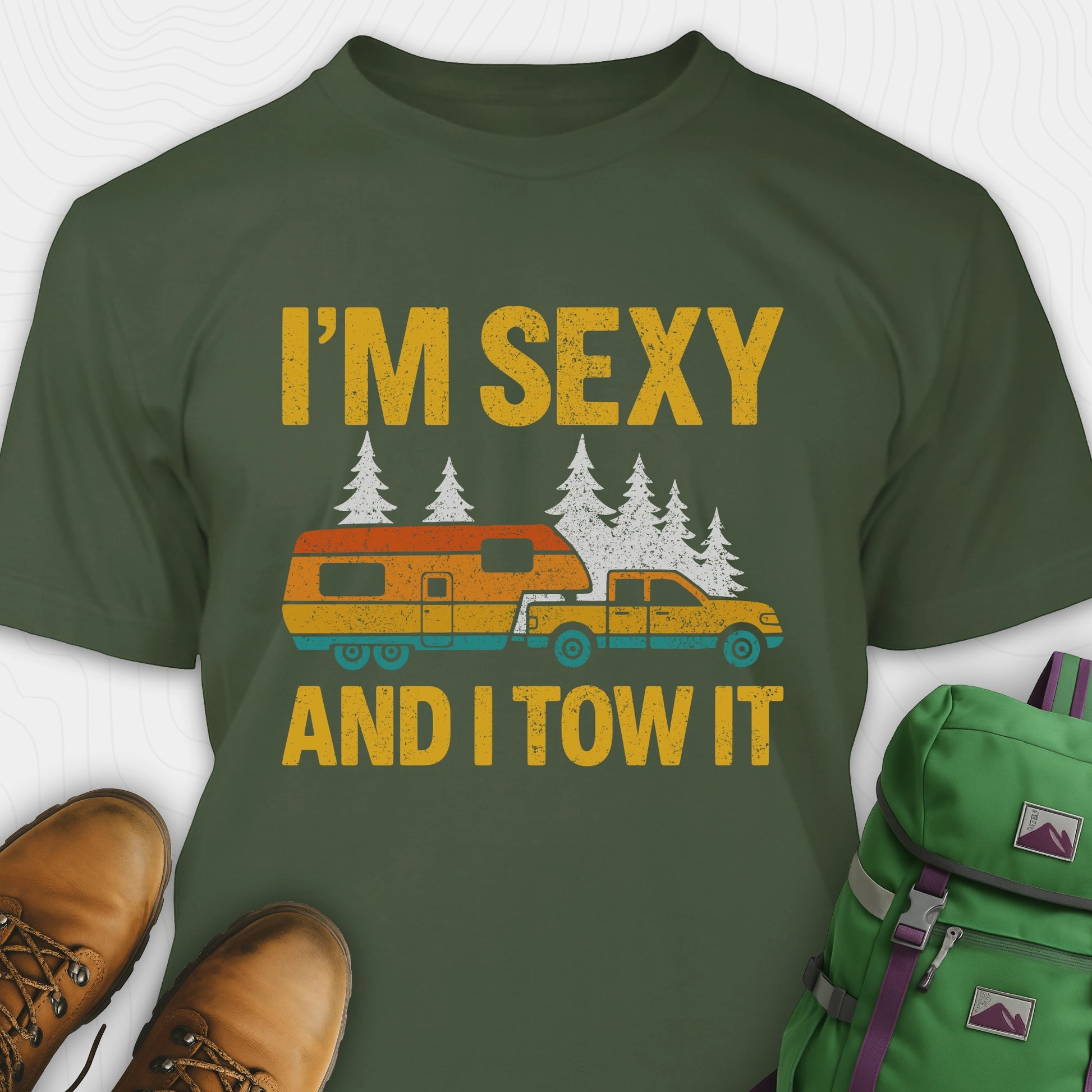 Military green fifth wheel t-shirt with “I’m Sexy and I Tow It” in distressed yellow text and a retro truck towing a camper graphic.