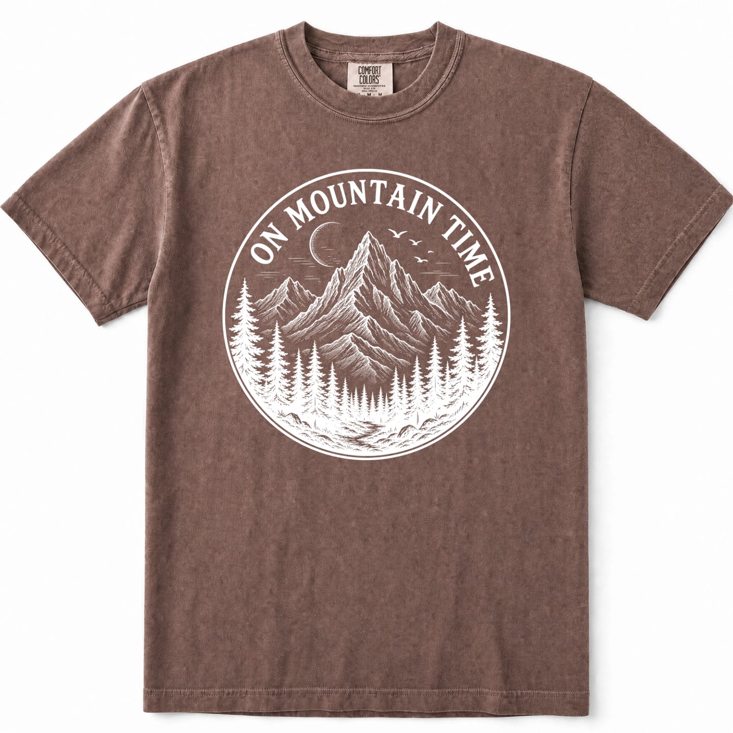 Espresso short-sleeve crewneck t-shirt with a white circular graphic on the chest depicting mountains, pine trees, and a crescent moon, with the text 'ON MOUNTAIN TIME'.