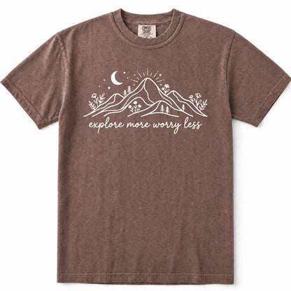 Espresso mineral-washed short-sleeve t-shirt with a white graphic of mountains, a crescent moon, and the text 'explore more worry less' printed on the chest.