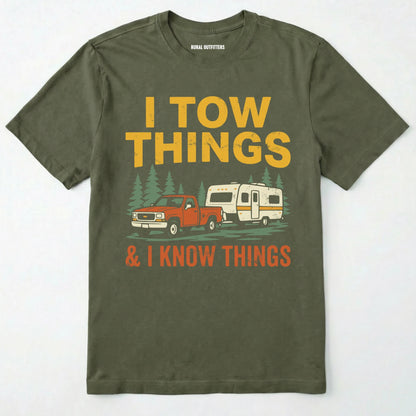 Military Green I Tow Things & I Know Things t-shirt with graphic of a truck towing a camper on a white background.