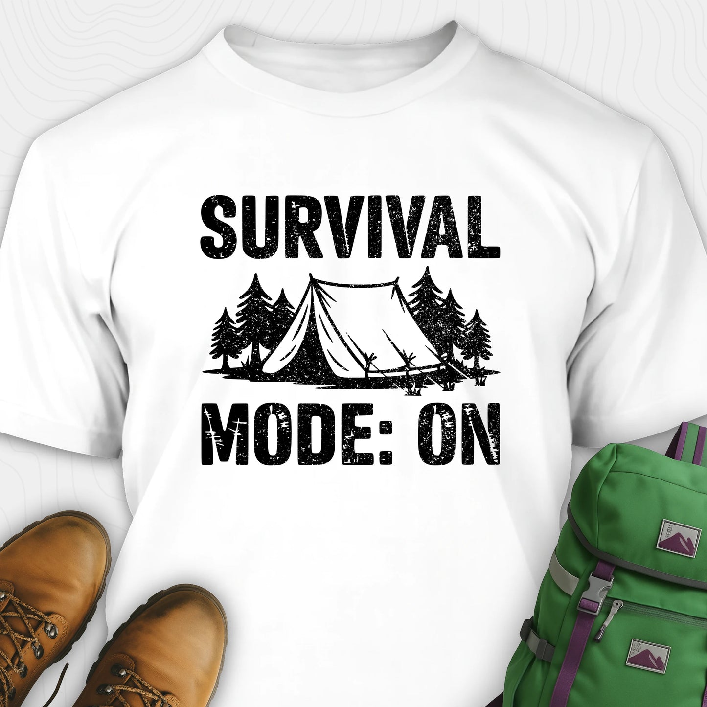 White bushcraft shirt with survival mode on text, featuring tent and pine tree design