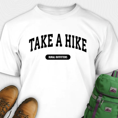 White t-shirt with 'Take a Hike' text, brown boots, and green backpack on a white background
