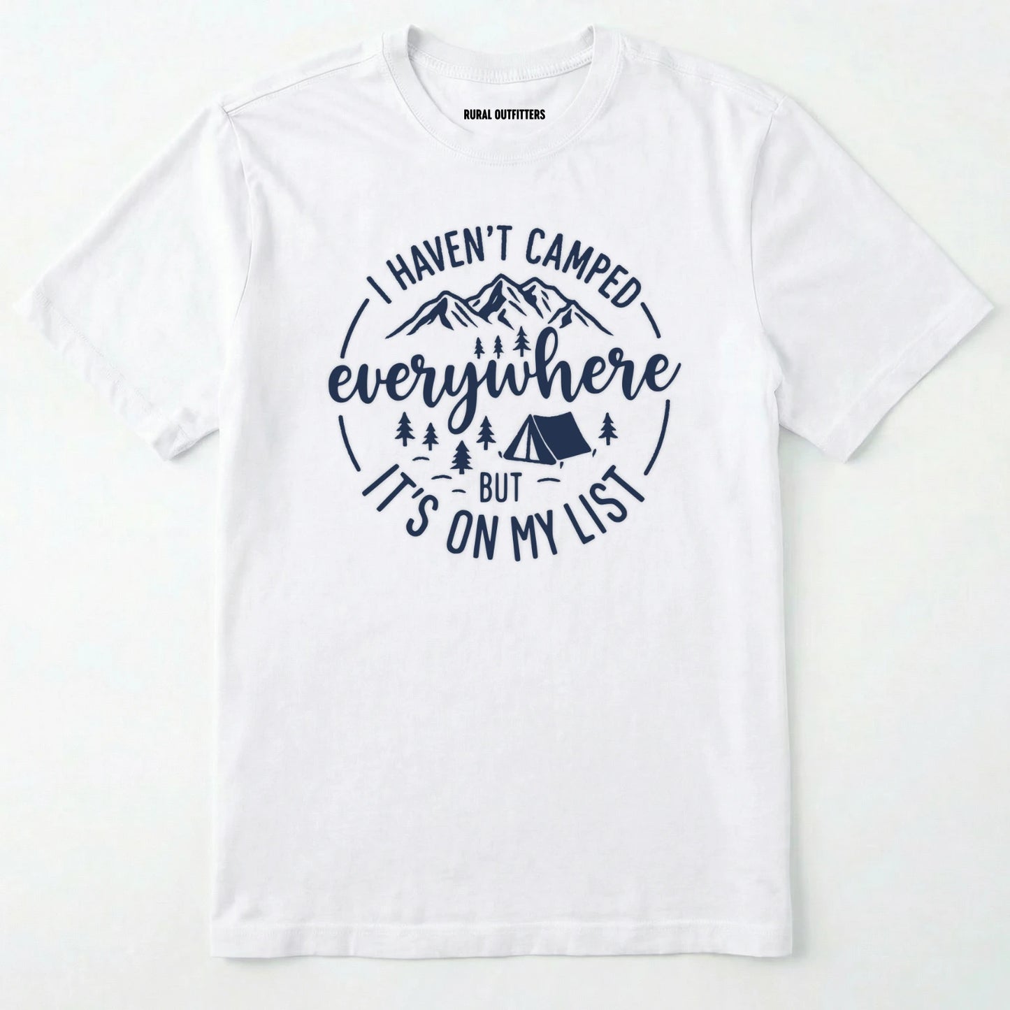 White funny camping shirt saying with mountains, trees, tent graphic and "I Haven't Camped Everywhere But It's On My List" text on a white background.