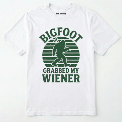 White bigfoot grabbed my wiener t-shirt with a funny design and text, on a plain white background.
