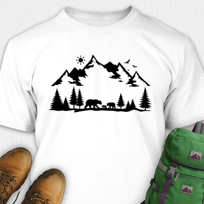 White wildlife t-shirt with black mountain and bear design, paired with brown boots and a green backpack on a white background.