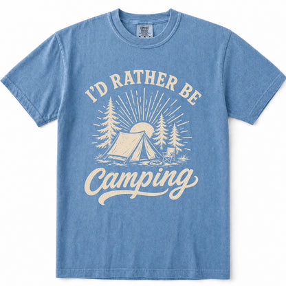 Blue Jean short-sleeve crewneck t-shirt with a vintage-style cream graphic on the front that reads 'I'D RATHER BE Camping' with a tent, trees, and sun illustration.