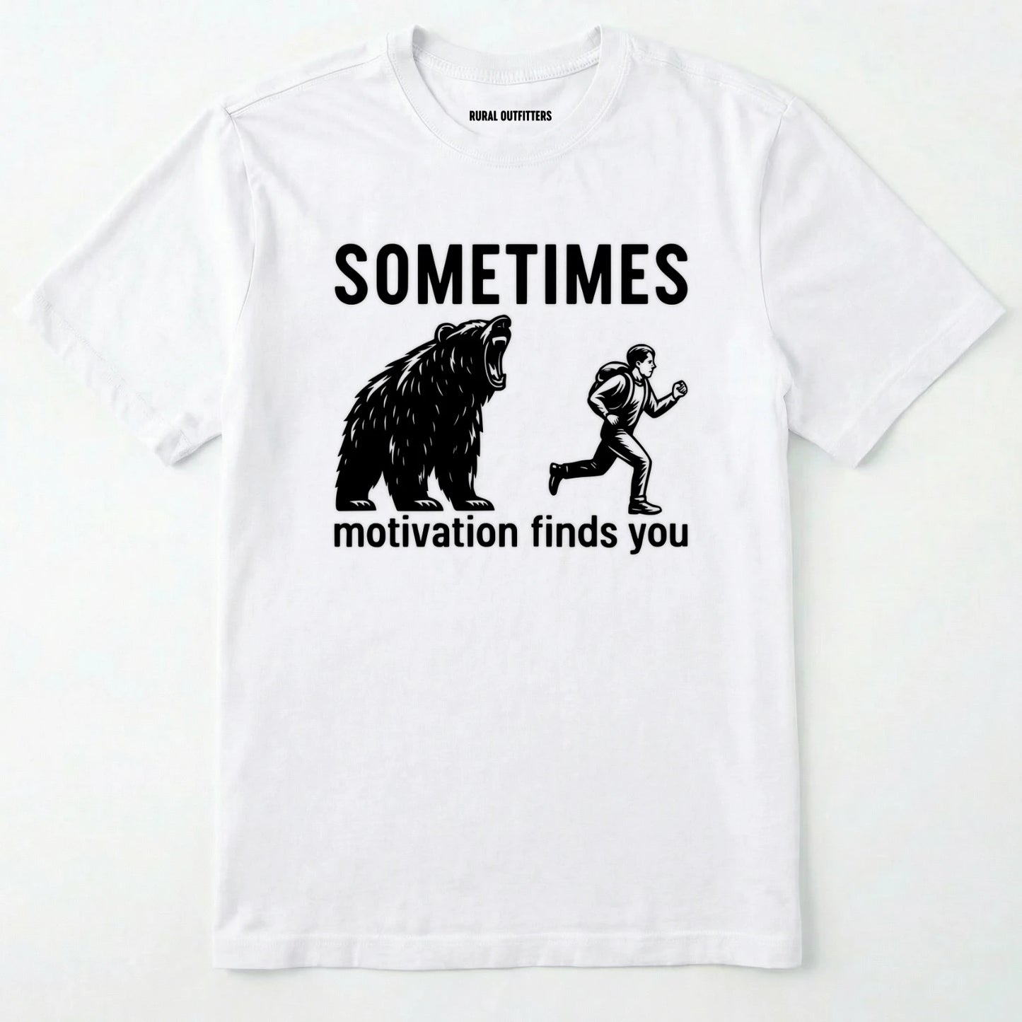 White motivational t-shirt with bear and person graphic and text 'sometimes motivation finds you' on a white background.