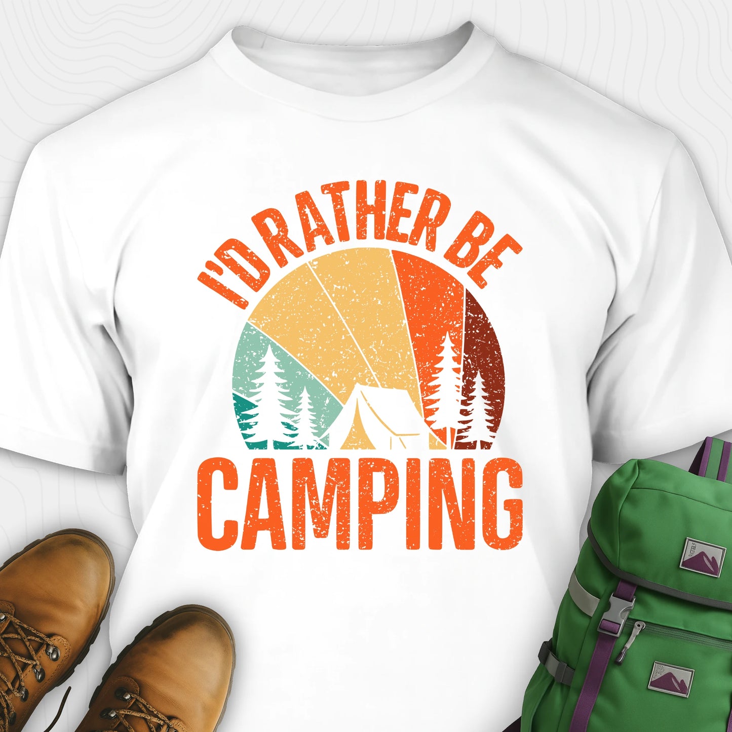 White t-shirt with 'I'd Rather Be Camping' design, brown boots, and green backpack on a white background