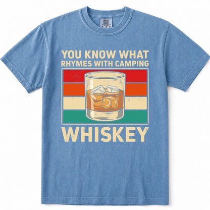 Blue Jean crewneck t-shirt with a vintage-style graphic on the front. The graphic features the text 'YOU KNOW WHAT RHYMES WITH CAMPING' above a retro striped background and an illustration of a whiskey glass, with 'WHISKEY' printed below in large cream letters.