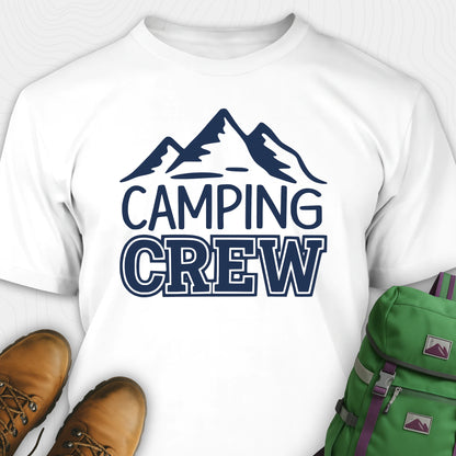 White camping crew t-shirt with 'Camping Crew' text and mountain graphic, paired with hiking boots and a green backpack.