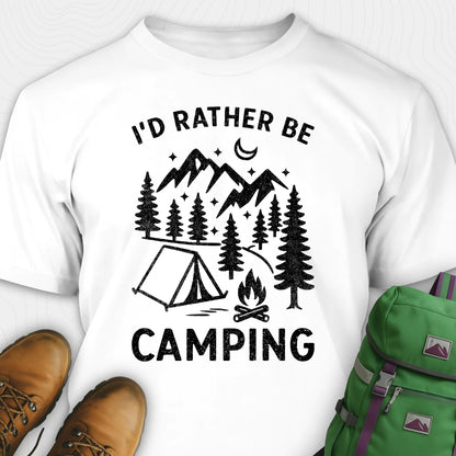 White t-shirt with 'I'd Rather Be Camping' design, brown boots, and green backpack on a white background