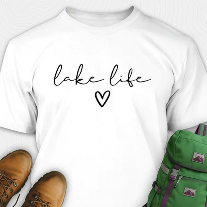 White lake life shirt with 'lake life' text and heart, paired with brown boots and a green backpack on a white background.